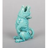 A Burmantofts Faience grotesque specimen vase glazed in turquoise. Formed as a seated temple dog