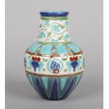 A Burmantofts Faience vase decorated in the Persian style. With incised foliage and glazed in red,
