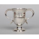 A George III silver twin handled pedestal cup, engraved with a cipher. Assayed London 1775. Makers