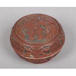 An 19th century Chinese cinnabar lacquer box and cover of circular form. Carved to depict a sage and
