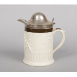 An early 19th century Adams dry bodied stoneware jug with silver plated mount. Sprig moulded with