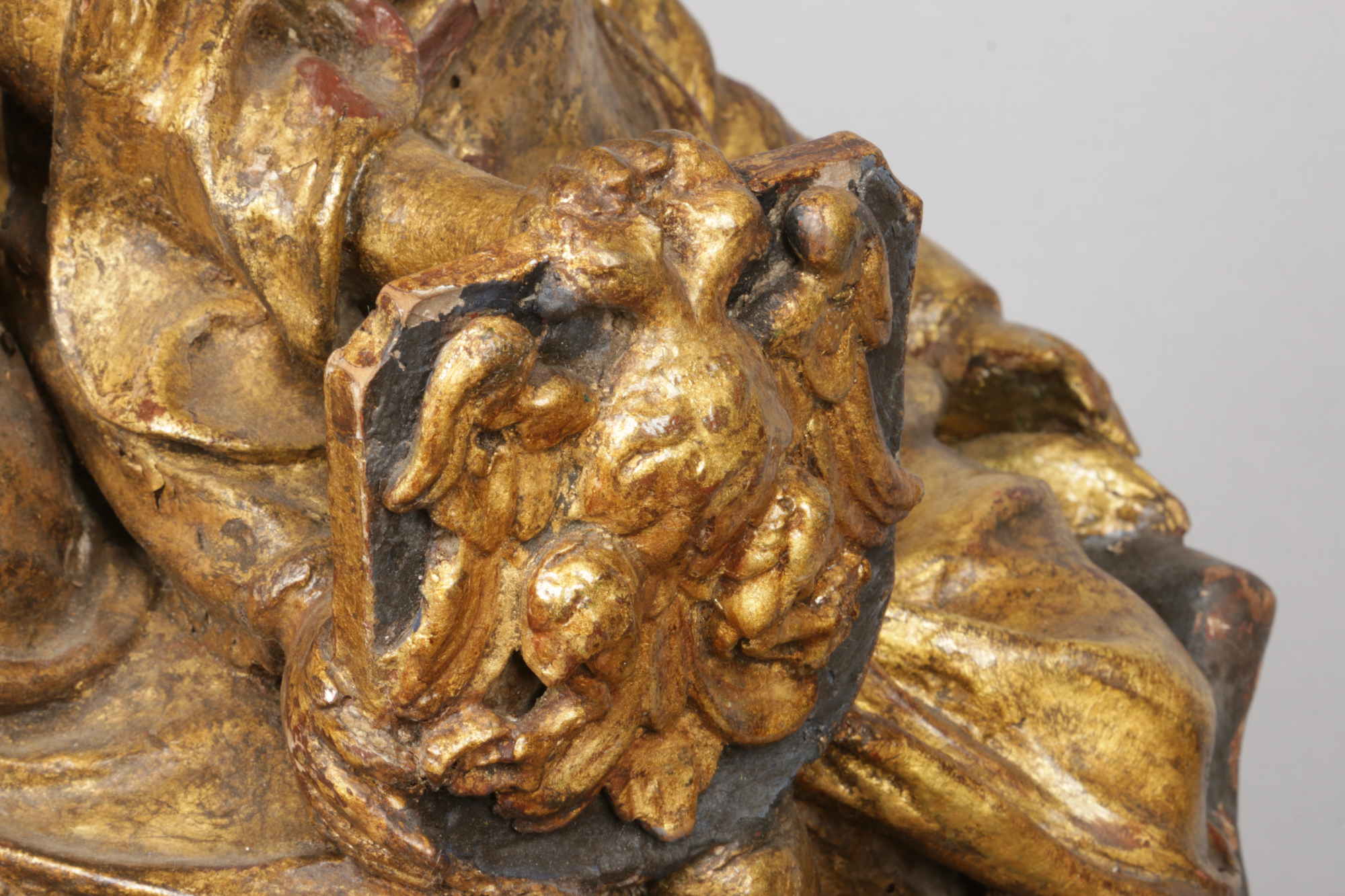 An antique Continental carved giltwood sculpture. Formed as two figures and a winged putti riding in - Image 2 of 4