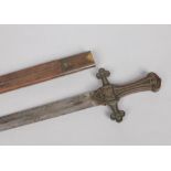 A British 1856 MkI drummers sword in leather scabbard. With double edged blade and cast bronze