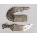 A middle eastern Janbiya / dagger. With horn grip and white metal adornments, 32.5cm.