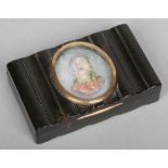 A 19th century tortoiseshell table snuff box with reeded moulding. Set to the top with a coloured