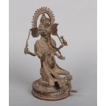 A 19th century Indian bronze statue of Lord Ganesh raised on a circular lead weighted plinth, 36cm.
