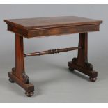 A William IV rosewood library table. Raised on reeded supports with acanthus carved terminals and
