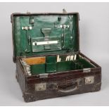 A gentleman's Victorian crocodile travelling vanity case with glass, ivory and silver accoutrements.