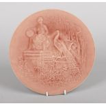 A Burmantofts Faience circular wall plaque by Pierre Mallet. Modelled in low relief with a Classical