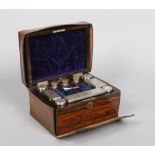 A Victorian coromandel fitted vanity box and accoutrements in tooled leather case. With silver