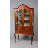 A Victorian marquetry dome top bookcase. With gilt metal mounts and raised on square scrolling