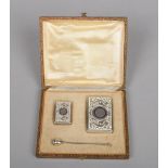 A cased Continental silver three piece smoking set comprising cigarette case, vesta and holder. With