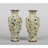 A pair of Japanese Meiji period cloisonne vases of fluted baluster form. Yellow ground and decorated
