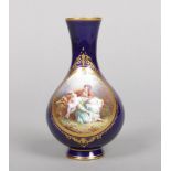 A Sevres bottle vase of baluster shape. Ground in gros bleu, gilded and painted with two panels, one