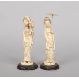 Two Japanese Meiji period carved ivory okimono on hardwood plinths. Formed as Bijin, one holding a