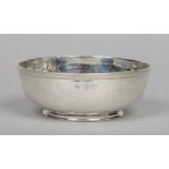 An Arts & Crafts planished silver bowl with reeded rim by Goldsmith's & Silversmith's Co. Ltd.