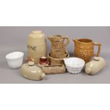 A quantity of mostly stoneware including jelly brawn moulds, wine storage barrel, bark effect jug