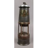 A William Maurice baby wolf miners lamp with brass vent slide and presentation plaque; presented