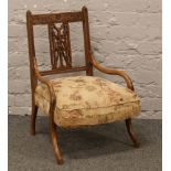 A Victorian carved walnut nursing chair.