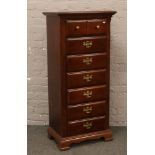 A tall standing seven drawer chest with brass mounts, 135cm x 62cm x 41cm