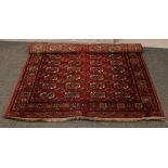 A red ground wool Bokhara rug 200cm x 132cm.