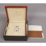 A boxed and cased Dreyfuss & Co. stainless steel bracket watch with silvered dial, baton markers,