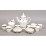 A Coalport six place bone china coffee service decorated with blue enamel and gilding including