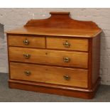 A Victorian mahogany chest of drawers with carved up stand and replaced brass metal handles.