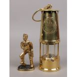 An Eccles type 6 miners re-lightable protector lamp along with a brass figure of a coal miner.