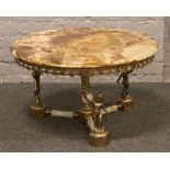 A circular brass based figural onyx top coffee table.