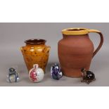 A terracotta jug with glazed rim along with a similar twin handled pot and four art glass