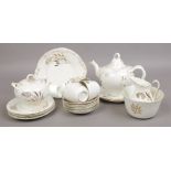 A porcelain part tea set decorated with gilt thistles.