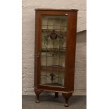 A mahogany stained glass corner display cabinet.