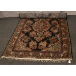 A blue ground wool rug with medallion design, 202cm x 129cm.