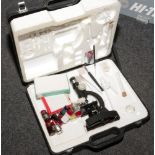 A cased students microscope set to include C.O.C microscope, slides etc.