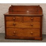 A Victorian mahogany chest of four drawers with carved gallery.