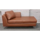 A brown leatherette chaise lounge on chrome supports. Length 170cm x Height 73cm x Depth 78cm.