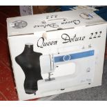 A Queens Delux electric sewing machine in original box with instruction manual.