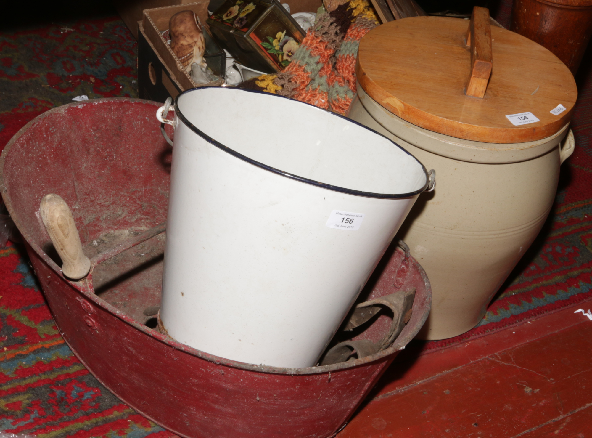 A painted galvanised steel seed dispenser, along with an enamel bucket and a twin handled