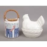 A Carltonware Jeans biscuit barrel and a white glazed pottery chicken formed egg basket.