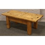 A pine coffee table with sliding compartments.