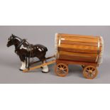 A ceramic figure of a shire horse with wooden gypsy caravan.