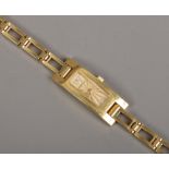 A ladies Gucci gold plated quartz bracelet dress watch with champagne dial case No. 3900L