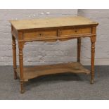 A Howard & Son oak writing table makers stamp and paper label to drawer.Condition report intended as