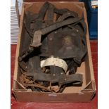 A box of leather and brass horse tack.