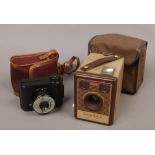 A 1930s black bakelite V. P. Twinroll film camera with bloomed bolco lens and carry case along