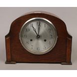 An oak cased eight day mantel lock chiming on a gong.