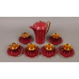 A burgundy and gilt Crown Devon Fielding's six place coffee service.