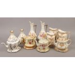 A collection of vintage tea pots on stands to include Carlton ware, Royal Crown Devon, three