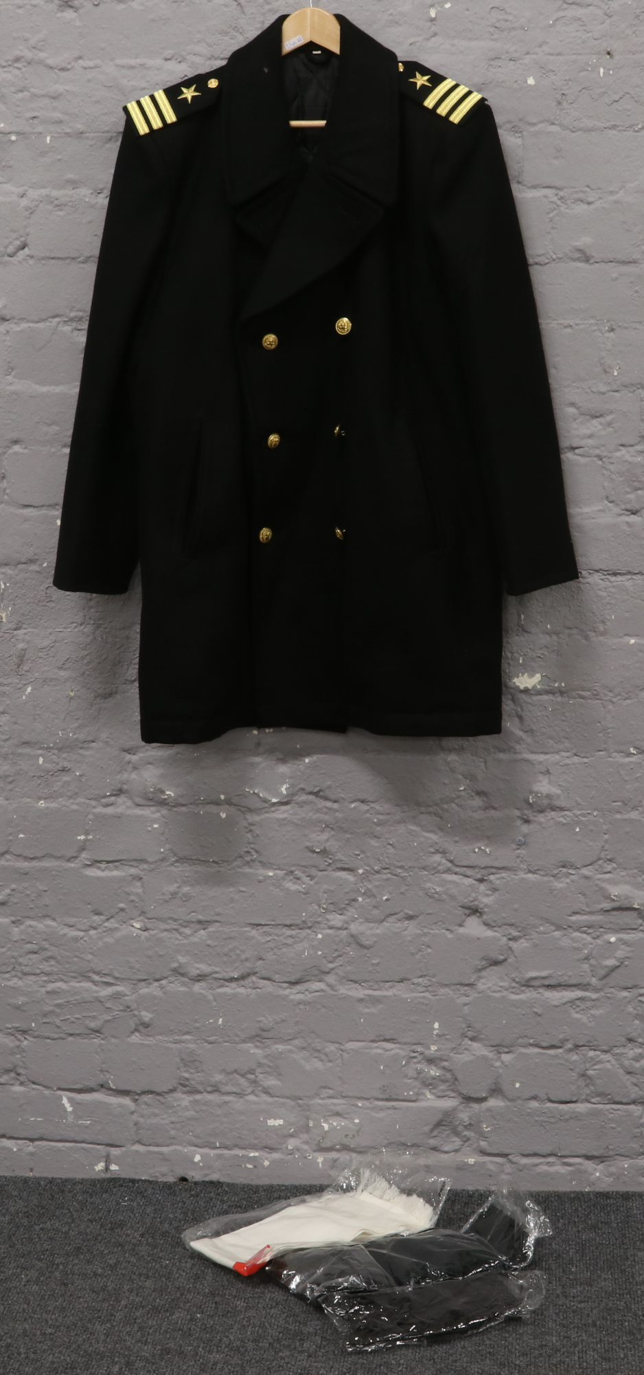 A genuine post World War II dark blue US Navy pea coat, along with two scarfs and a pair of black